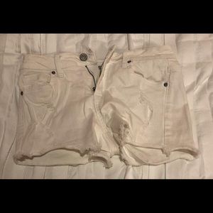 White ripped shorts
